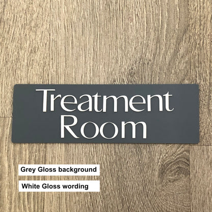 Sign with 'Treatment Room' text on a wooden background