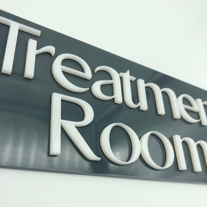 Sign with 'Treatment Room' text on a gray background