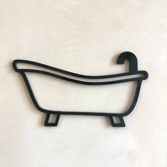 A black acrylic bathroom door sign shaped like a bathtub outline with a hook on the top rear side, displayed against a neutral background.