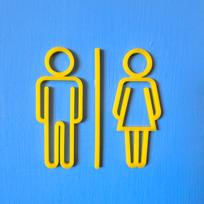 Yellow male and female restroom signs on a blue background