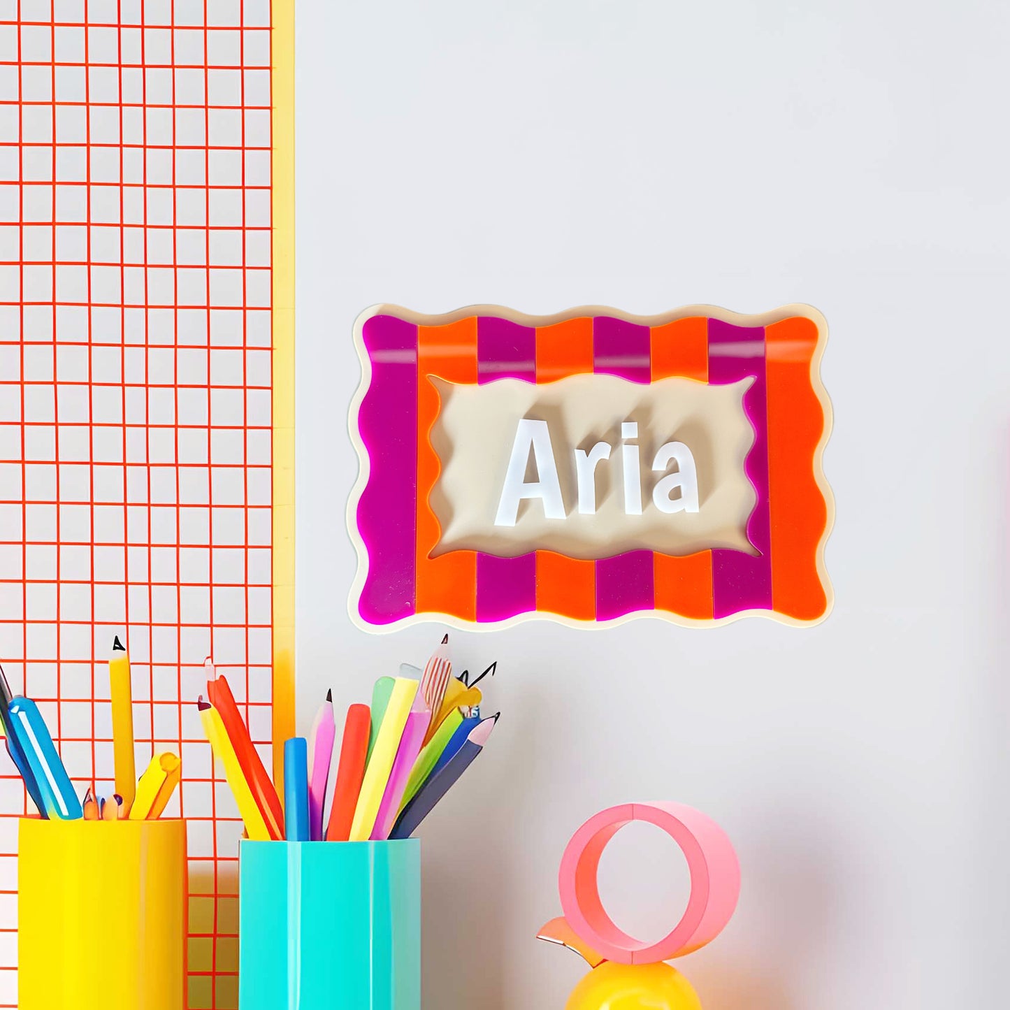 Name picture in colourful frame on the wall near children's desk