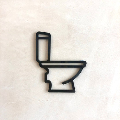 minimalist WC bathroom sign mounted on door