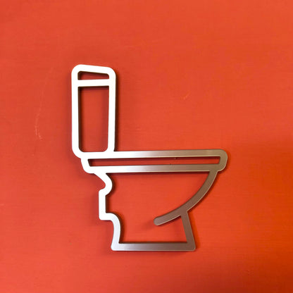 modern acrylic toilet door sign in silver on red wall