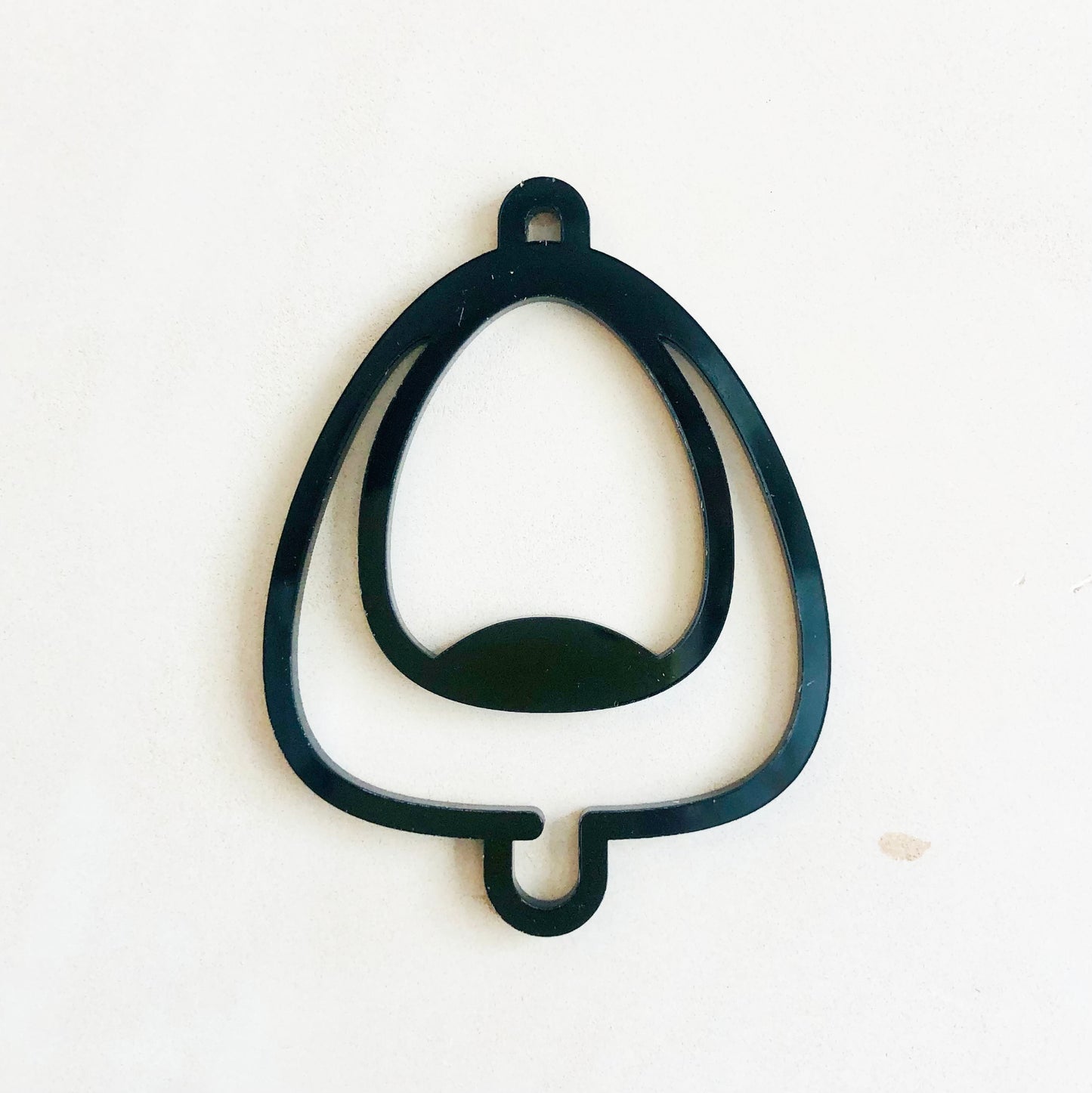 Black acrylic urinal symbol on a white background