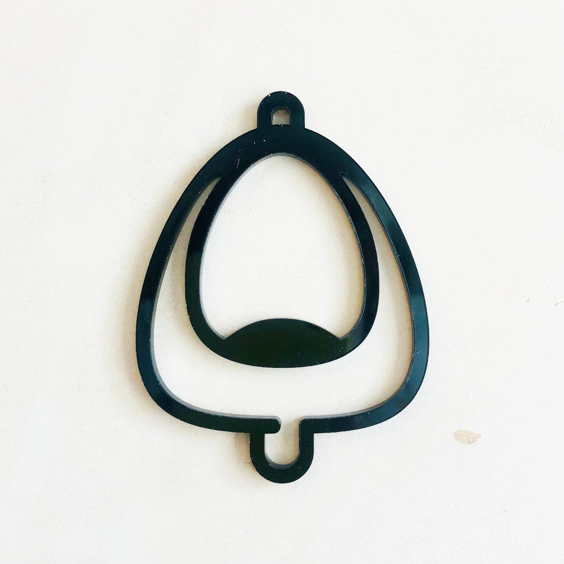 Black acrylic urinal symbol on a white background