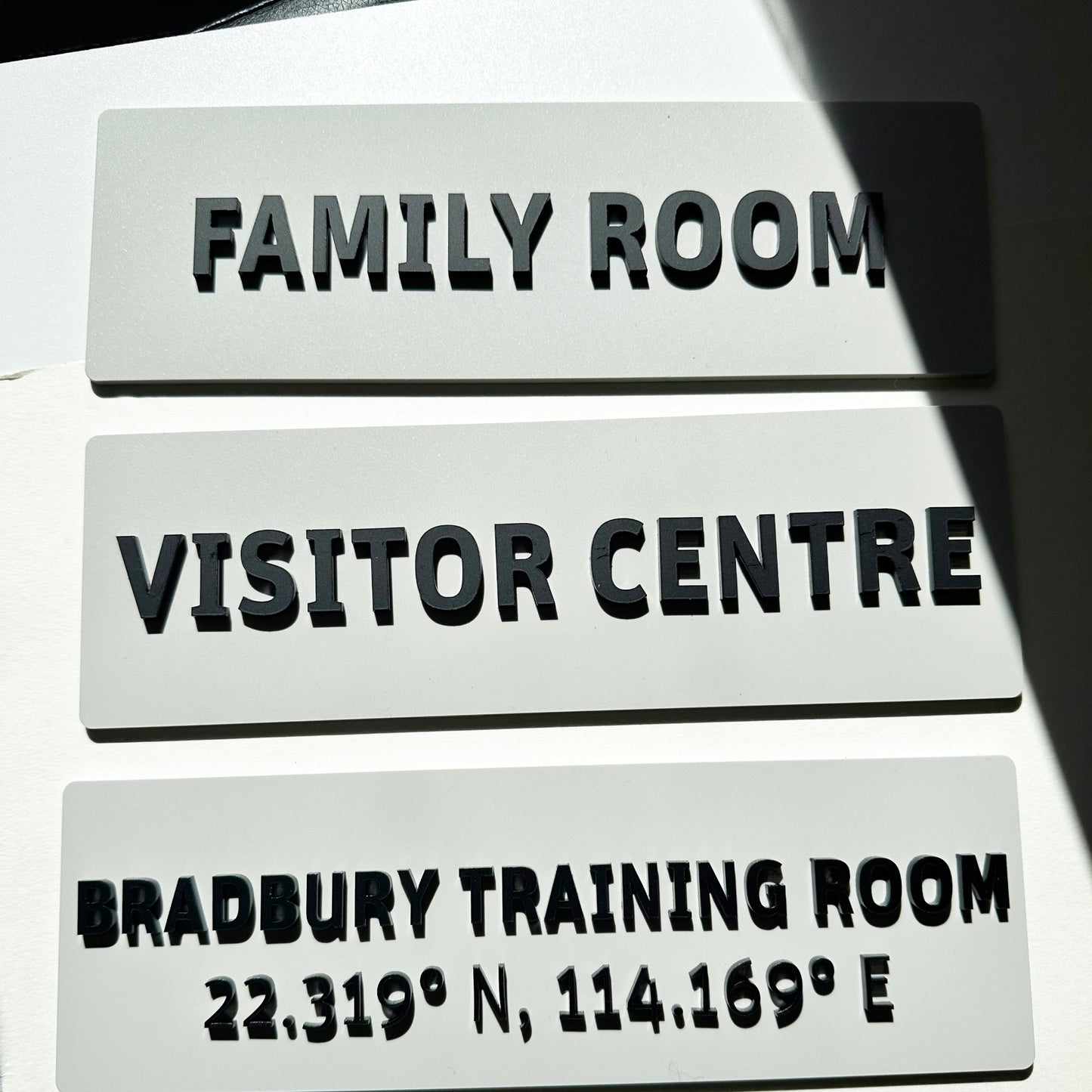 Three signs labeled 'Family Room', 'Visitor Centre', and 'Bradbury Training Room' with coordinates.