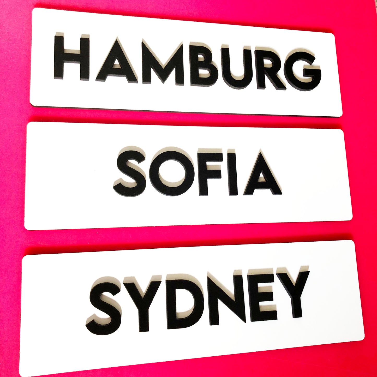 White signs with black letters world city name signs