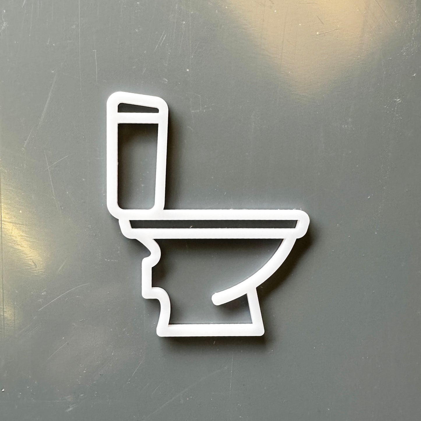 white toilet symbol on grey backgroud